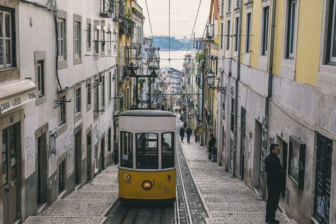 A tram on top of a hilly street in Lisbon.