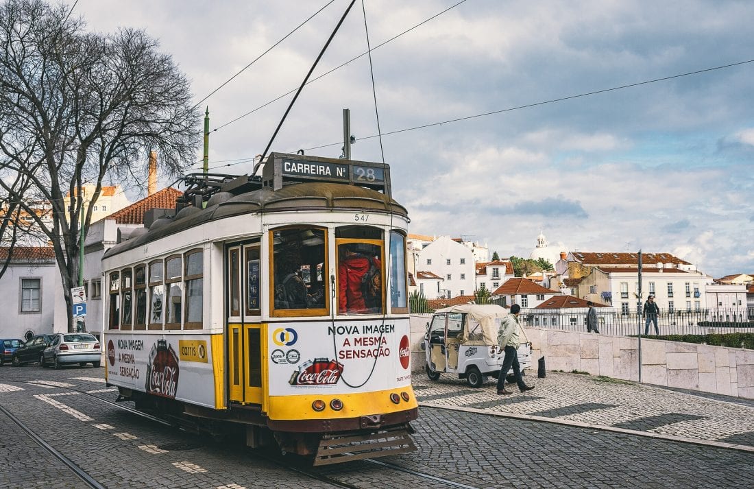 The number 28 tram on a street in Lisbon