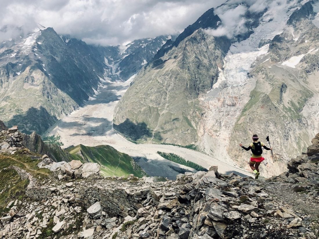 A woman hiking down a mountain in Aosta valley in Italy