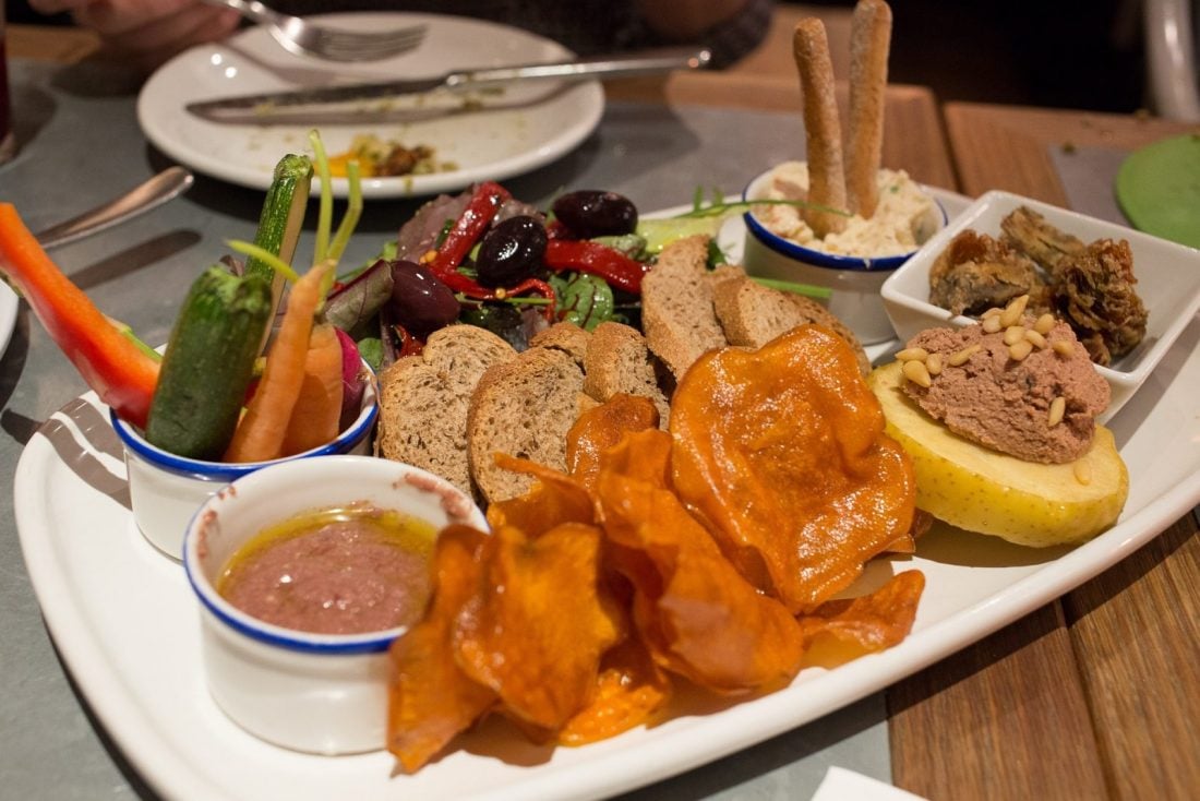 Various tapas and sauces crammed on a large plate