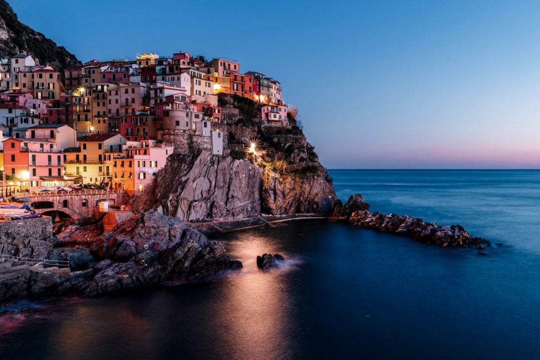 Buildings on a cliff by the water in Cinque Terre, Italy.