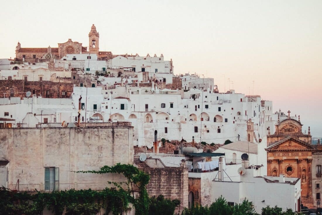 White buildings of Ostuni, Italy during sunset.