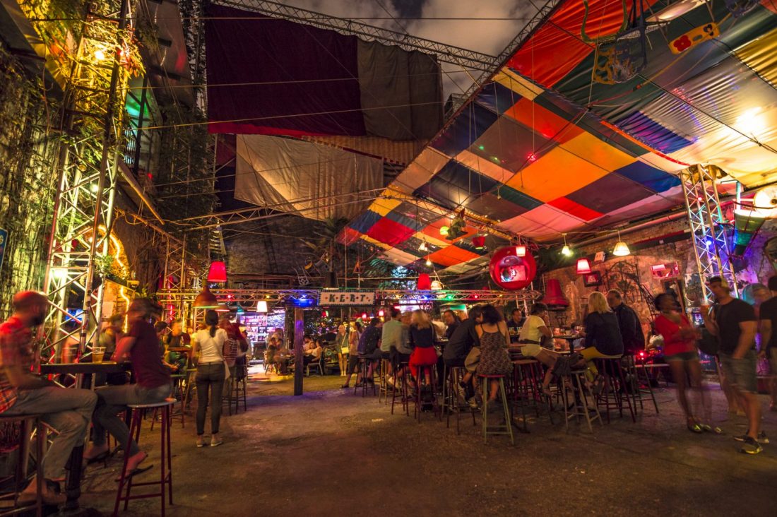 People sitting at tables enjoying Budapest nightlife at Szimpla Kert