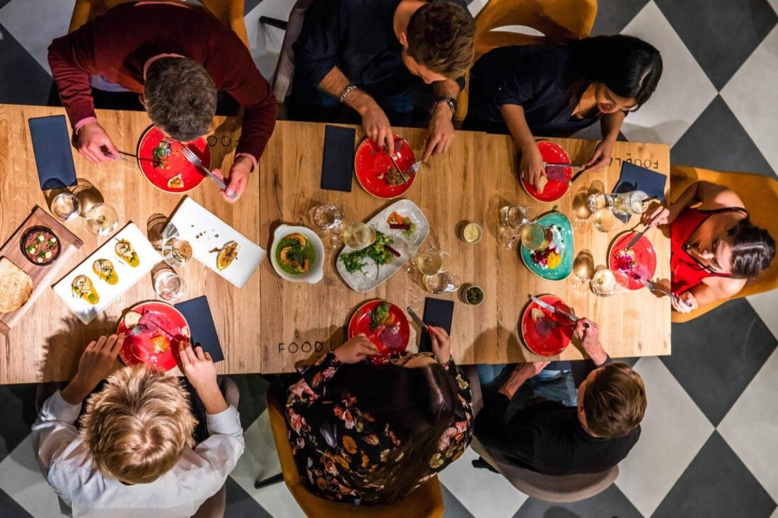 people sitting together in a restaurant and eating