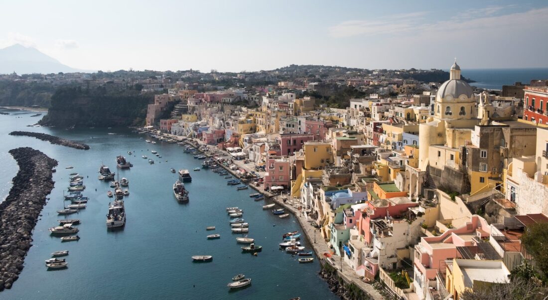 Buildings and boats along the harbor in Procida, Italy.