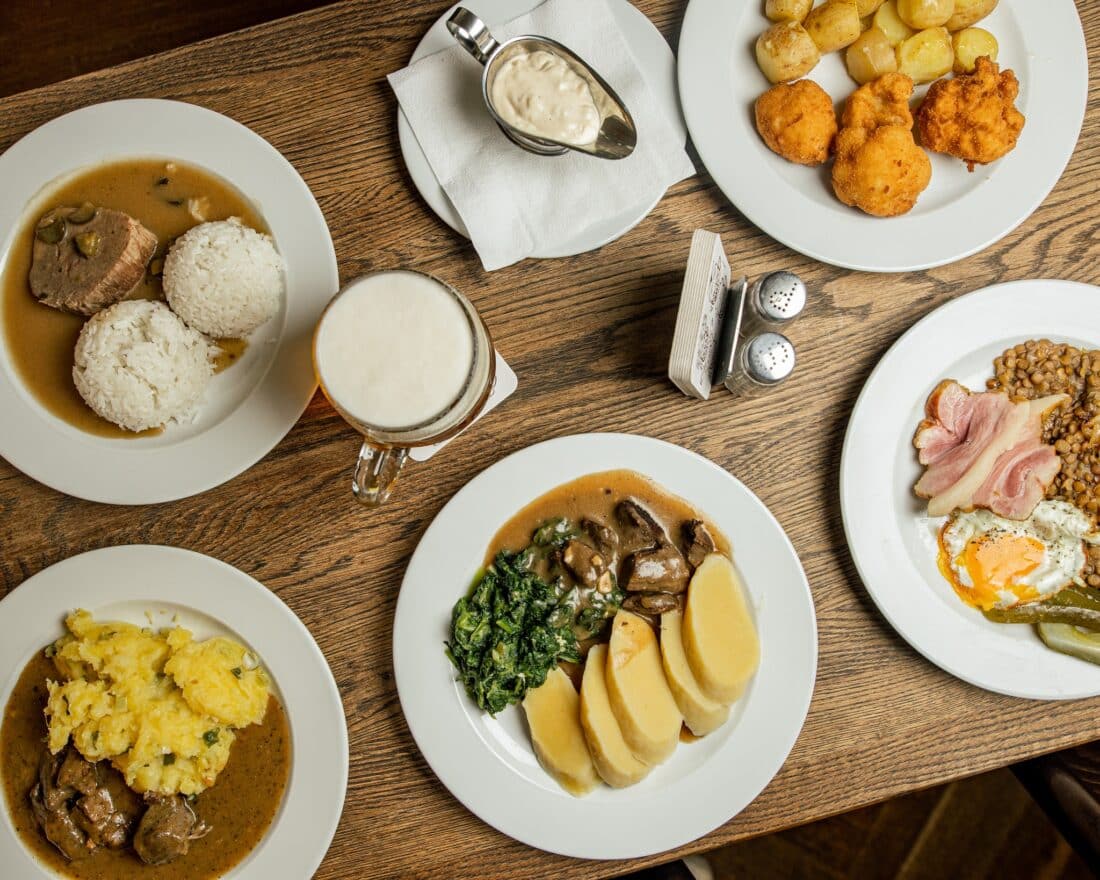 Various plates of traditional Czech food on a table in Prague