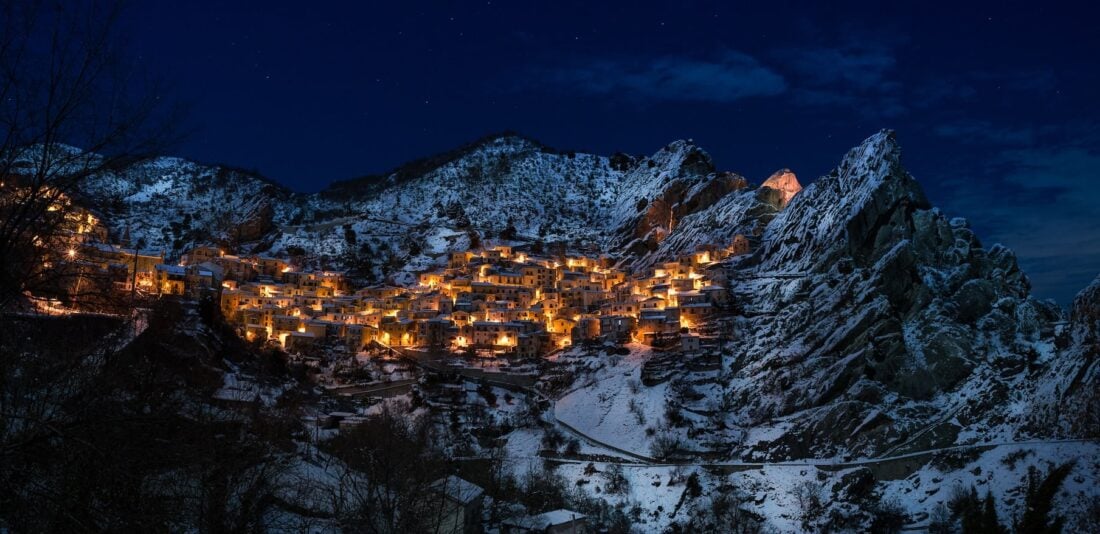 Lights on in buildings at night in Castelmezzano, Italy