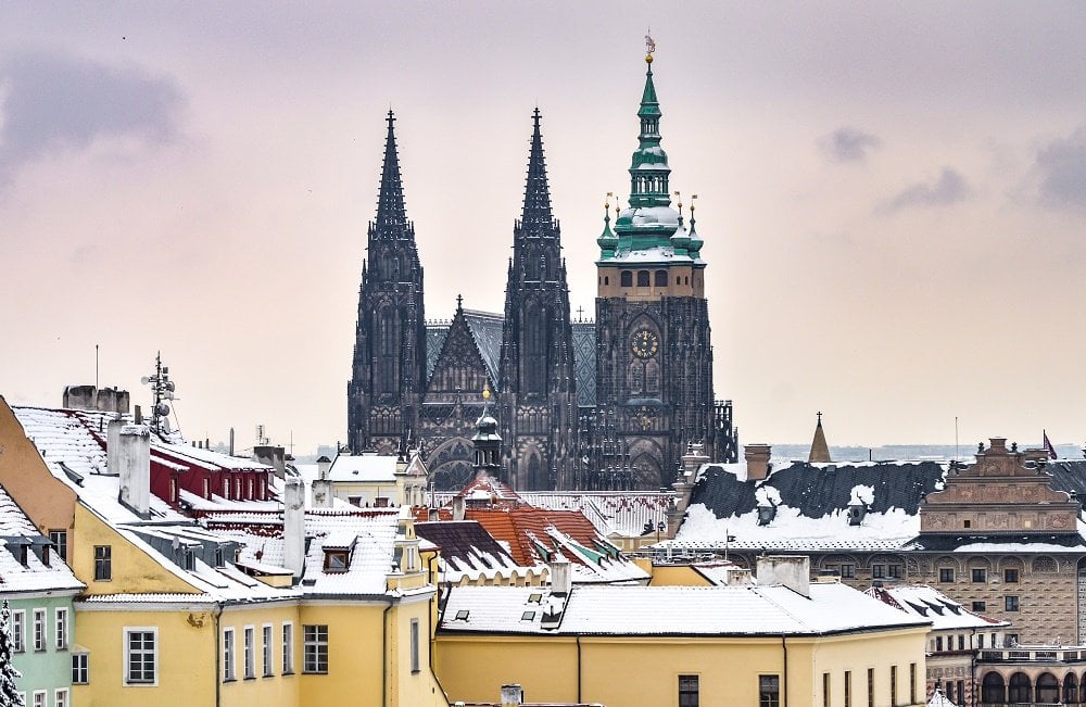 snow on rooftops in Prague and Prague Castle