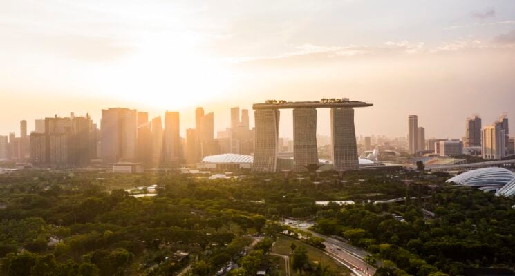 sun rising over the Singapore skyline