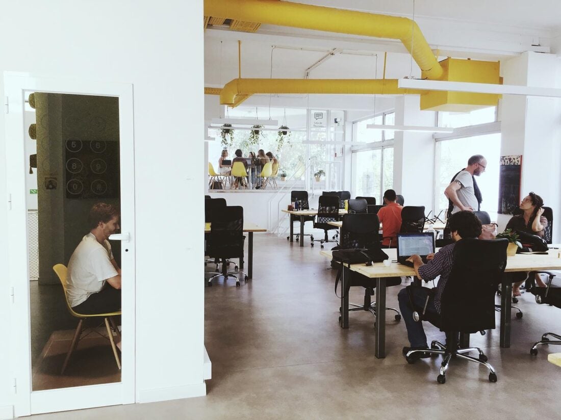 People working remotely at desks in Resves coworking lisbon