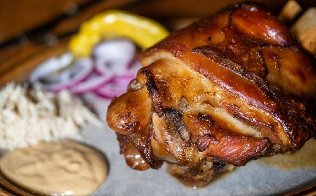 Roasted pork leg with mustard on a plate in Prague