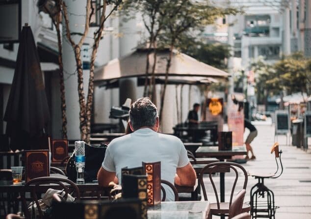 man sitting with back to camera at cafe in Singapore