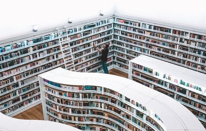 man looking at books in Singapore library