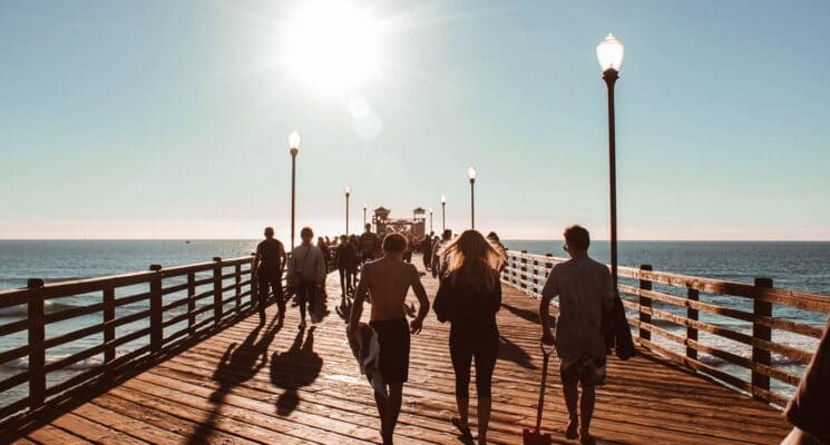 people walking on a pier in san diego