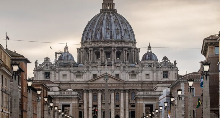 View of a man walking in front of the Vatican in Rome