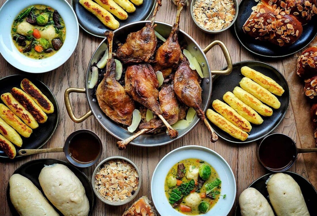 Duck and other plated traditional Czech foods on a table in Prague