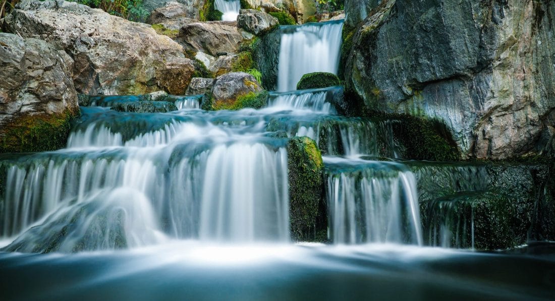 a lush small waterfall in Bali, Indonesia